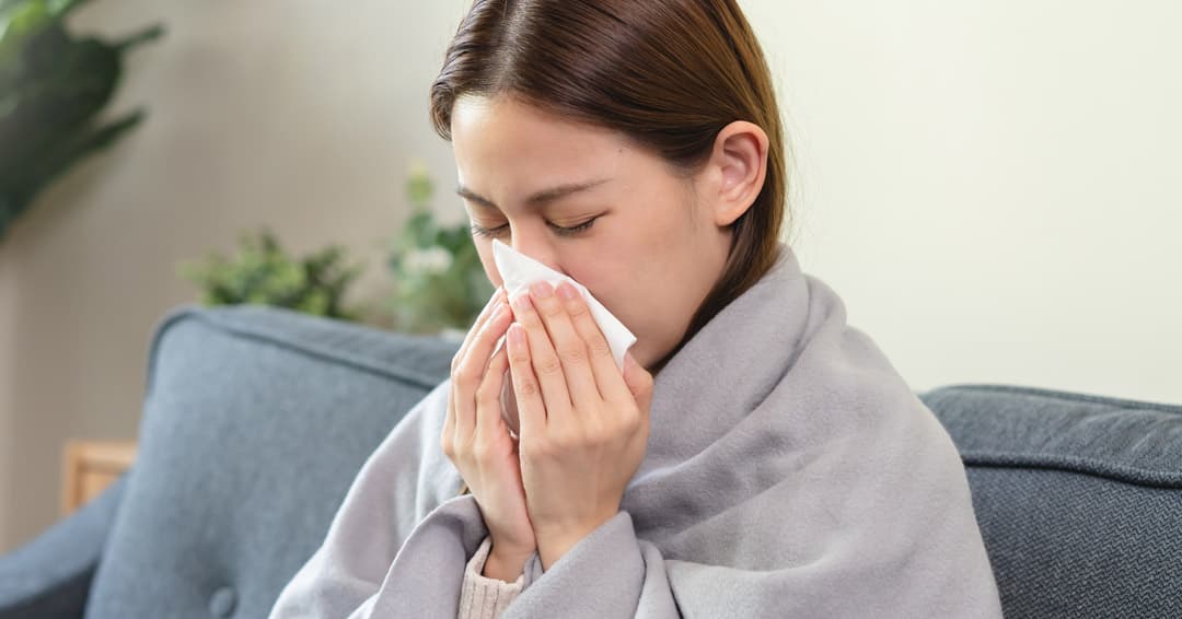 Woman experiencing nasal congestion and sinus discomfort