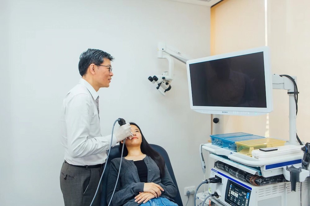 Dr Ong Yew Kwang performing a nasal endoscopy on a patient for further evaluation